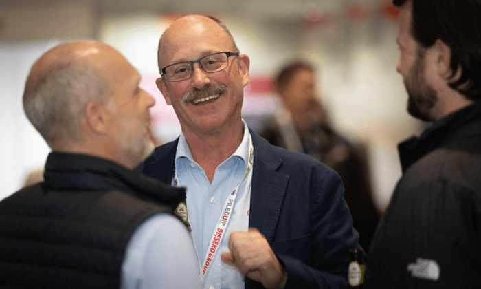 3 smiling people in a conversation