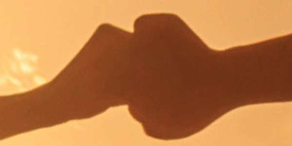 small hand reaching out to large hand