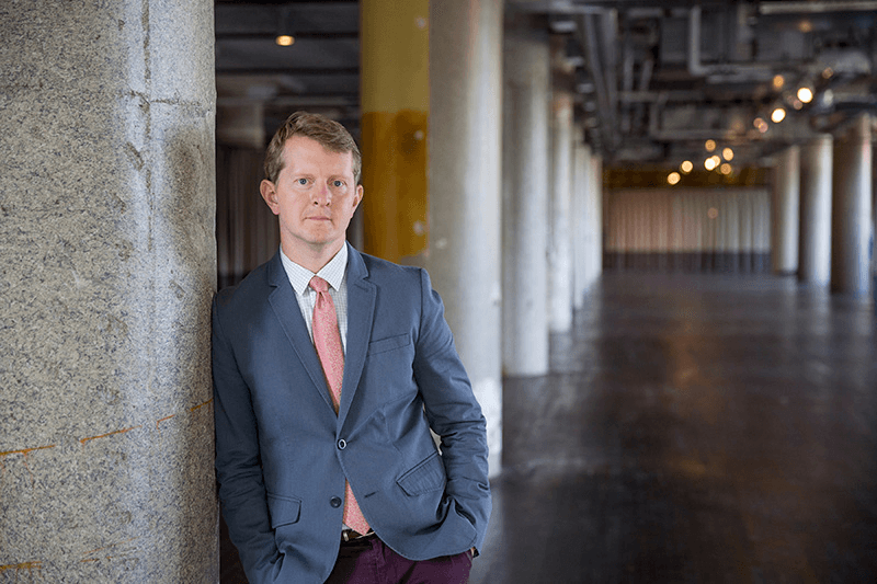 ken jennings leaning against a pillar indoors
