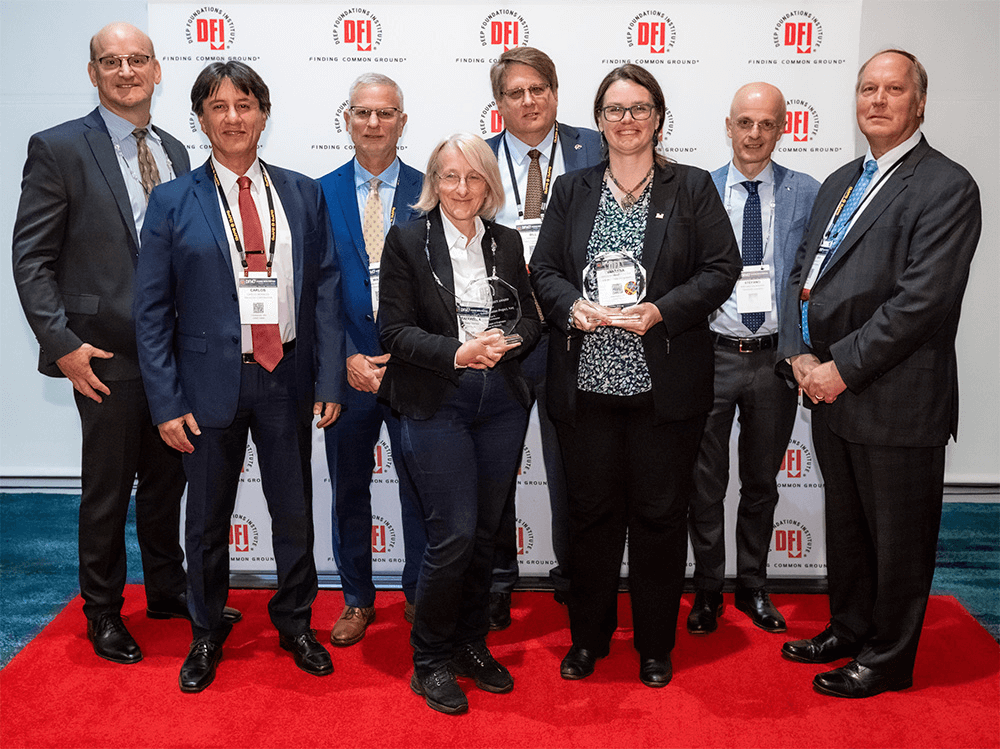 group of 8 posing with awards