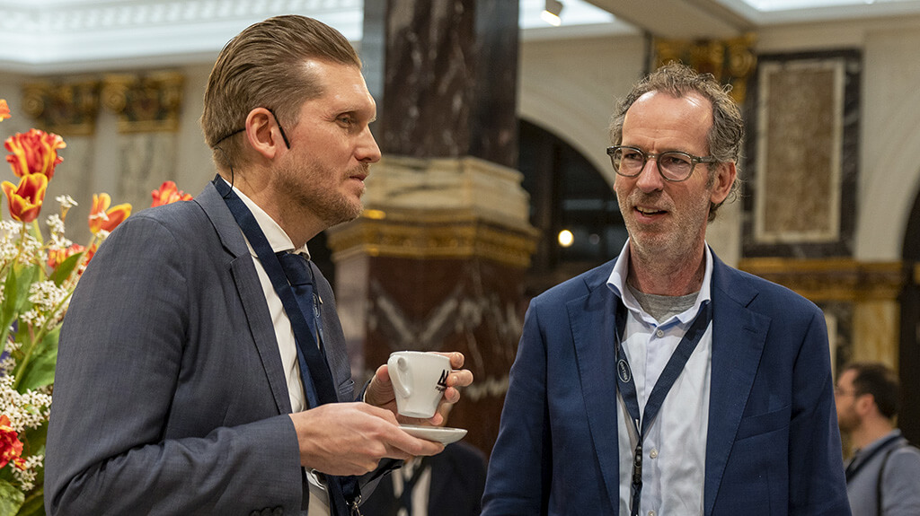 Two people in a conversation at a DFI of Europe Event