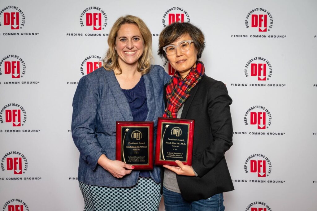 2 women holding plaques