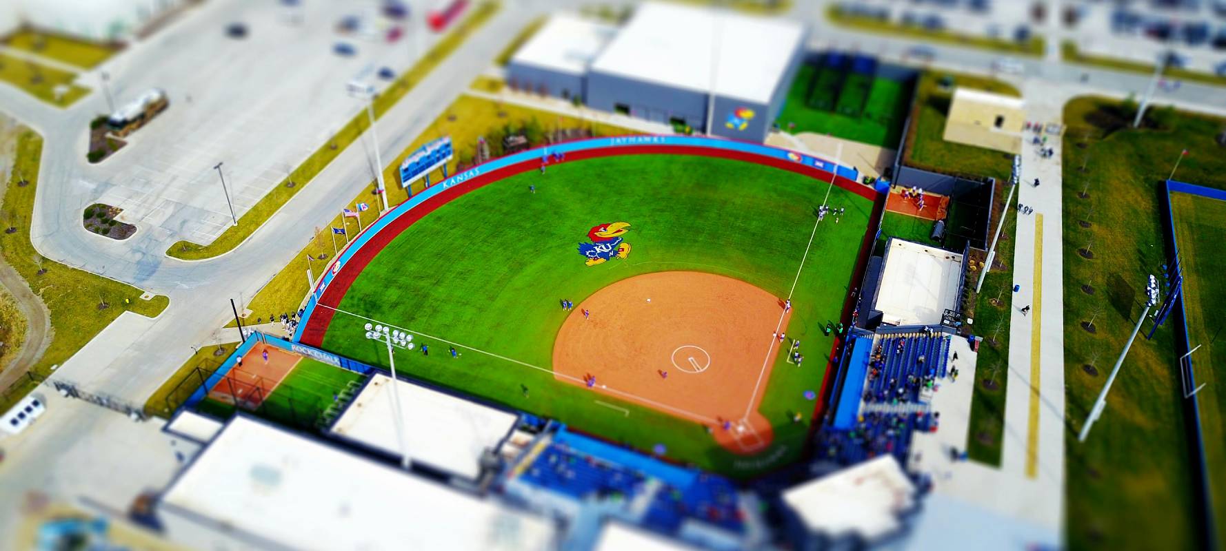 Birds eye view of a baseball stadium with a cartoon bird painted in the field.